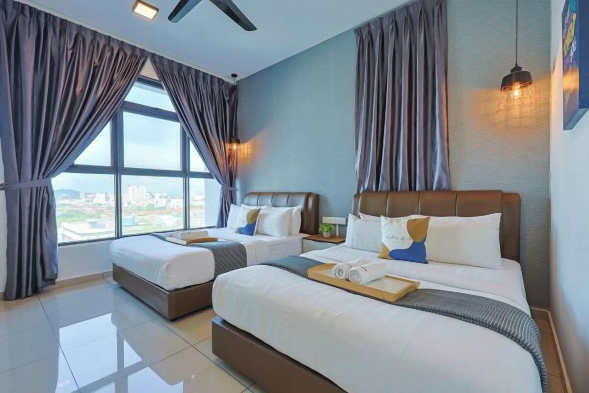A hotel room with two beds, a large window, and a city view.