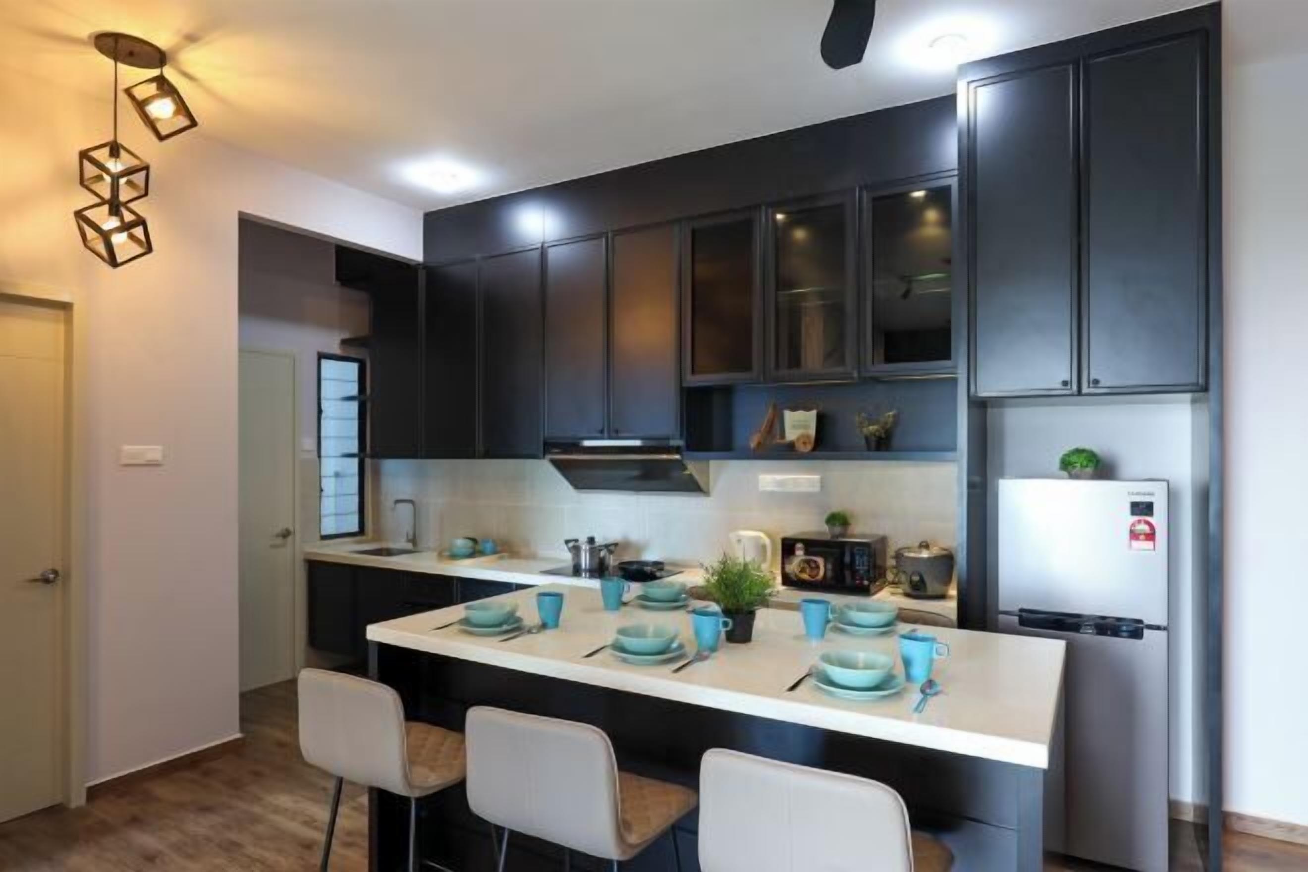 Una cocina moderna con armarios oscuros, una encimera blanca y vajilla azul.
