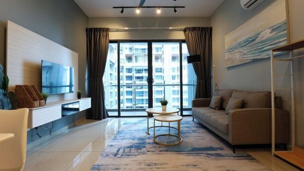A modern living room with a flat-screen TV, a sofa, a coffee table, and a ceiling fan. - Atlantis Residence Premium By I Housing (Melaka)