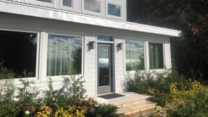 A modern two-story house with large windows and a front porch. - Lakefront Leisurely Hideaway - Private and Peaceful (Kincardine)