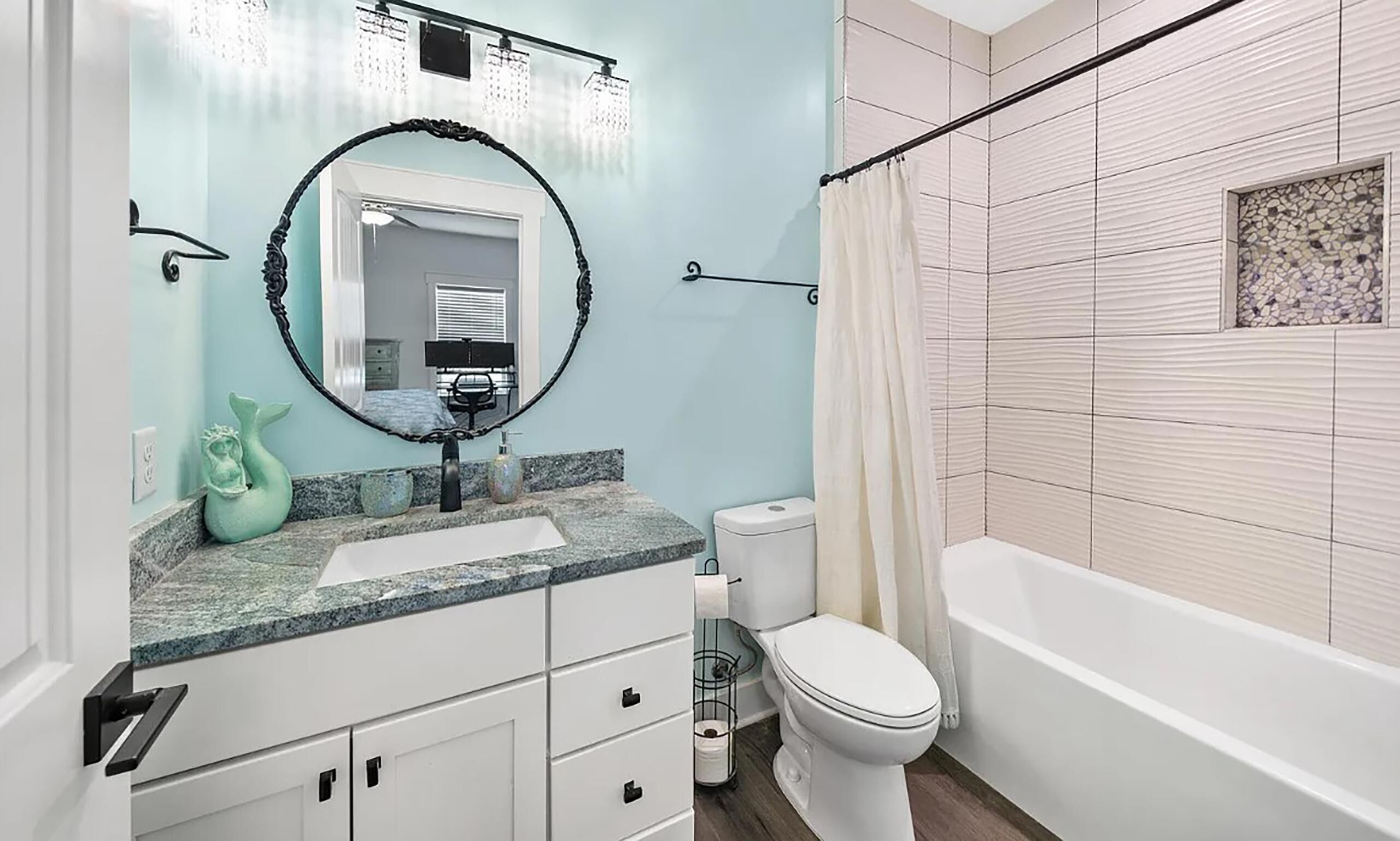 A bathroom with a white sink, a toilet, and a bathtub.