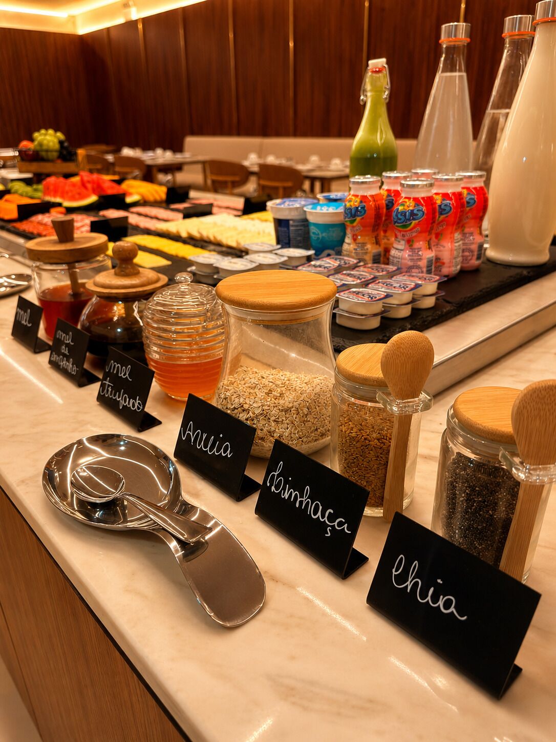 A buffet area with various food items and condiments.