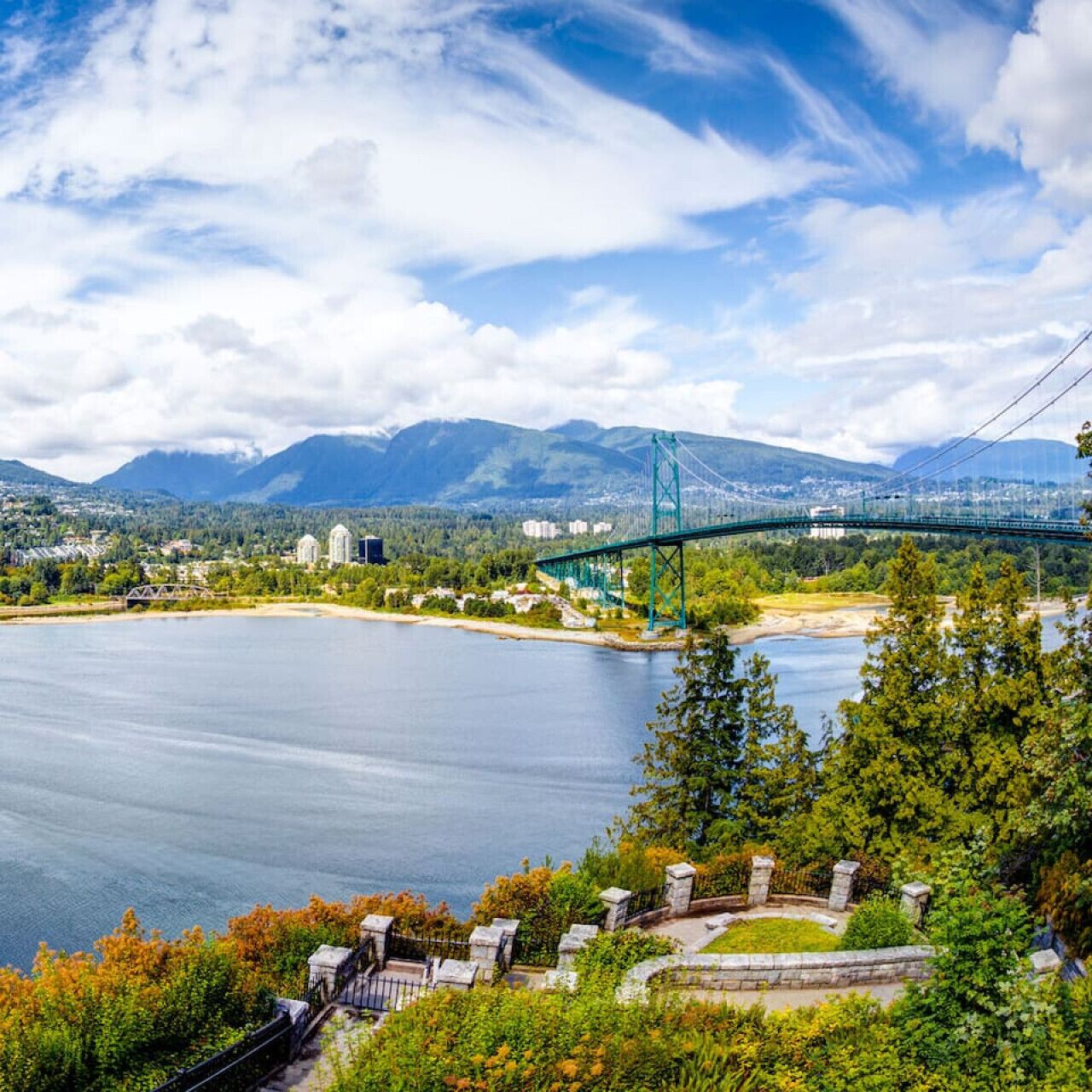 A bridge over a river with mountains in the background.