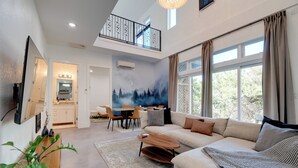 Una sala de estar moderna con un sofá, una mesa de centro y un comedor con sillas y una mesa.