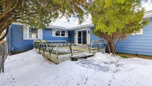 A blue house with a covered patio area and a tree in front. - 9 Mi to Lake George Village: Home in Queensbury (Queensbury)