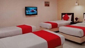 A hotel room with three beds, a TV, a lamp, and a small table. - Syajie Koptown Hotel (Segamat)