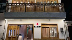 Un bâtiment à deux étages sur lequel on peut lire l’inscription « BINDI HOSTEL ».