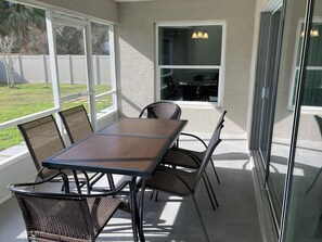Enjoy al fresco dining on the patio with a table and chairs.