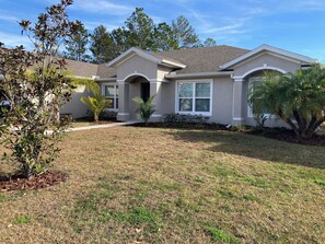 Stylish single-story home with a central entrance and well-manicured yard.