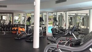 A gym with treadmills, elliptical machines, and weight equipment. - Teega Residence Waterfront Living (Iskandar Puteri)