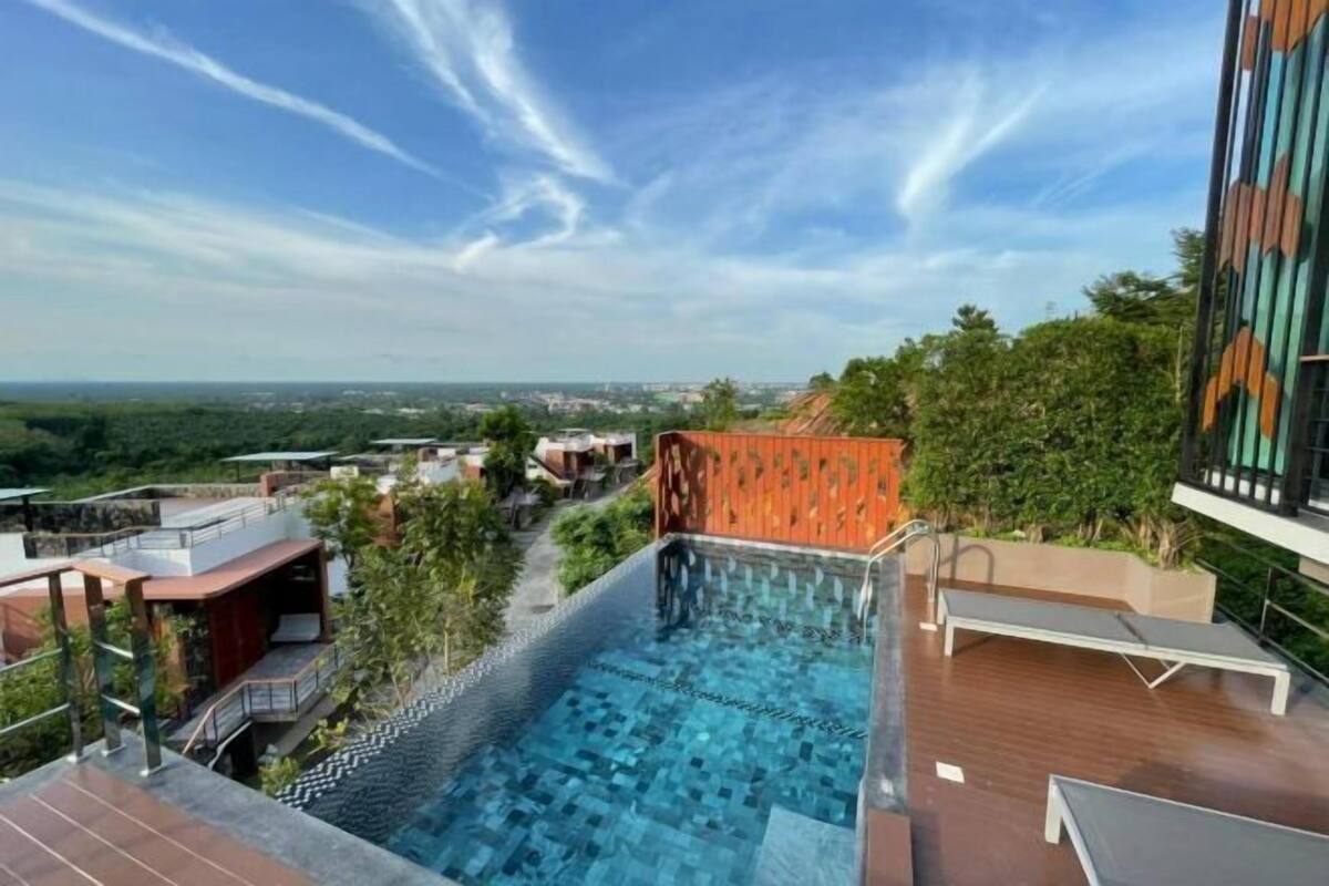 A rooftop infinity pool with a clear view of the cityscape.