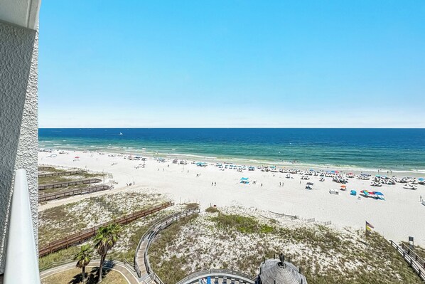 A beach with a clear view of the ocean and a sandy shore.