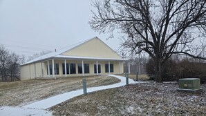 A building with a covered porch and a snow-covered lawn. - Spacious House Ideal for Sports Teams, Across from Spooky Nook in Manheim, PA (Manheim)