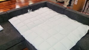 A sectional sofa with a quilted white cover. - Spacious House Ideal for Sports Teams, Across from Spooky Nook in Manheim, PA (Manheim)