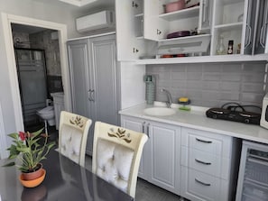 Fridge, microwave, stovetop, coffee/tea maker