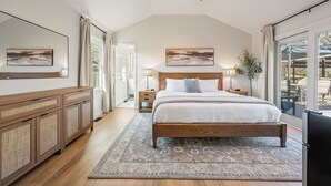 A bedroom with a large bed, wooden headboard, bedside tables, a ceiling fan, and a view through a large window. - Relaxing Private Ranch Retreat–10 Mins to Downtown. Complete w/ your own Urinal! (Nashville)