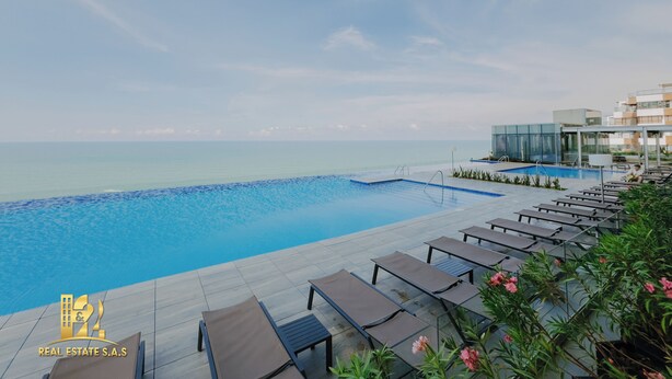A poolside area with lounge chairs and a clear view of the sea. - Luxurious & Modern Apartment 1503 Building h2 (Cartagena de Indias)
