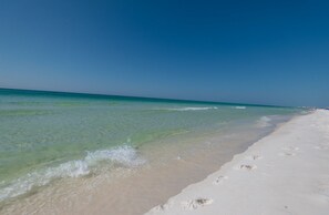 A beach with clear turquoise water and white sand.