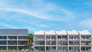A modern hotel with multiple floors, large windows, and balconies. - Blue Mountain Condos #22 (Santa Rosa Beach)