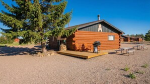 A log cabin with a deck, outdoor seating, and a grill area. - "A" Antelope Cabin - South Fork (South Fork)