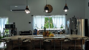A modern kitchen with a central island, stainless steel appliances, and pendant lighting.