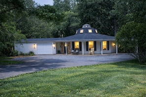 A single-story house with a covered porch, a garage, and a driveway. - New!  8Days a Week - Octagonal home for a unique stay (Floyd)
