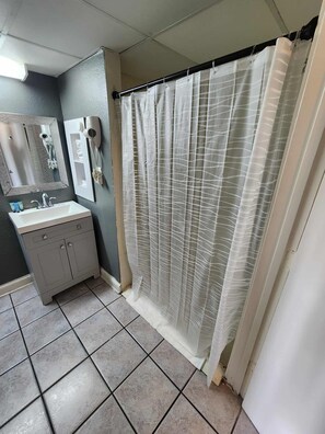 Shower, hair dryer, towels, shampoo