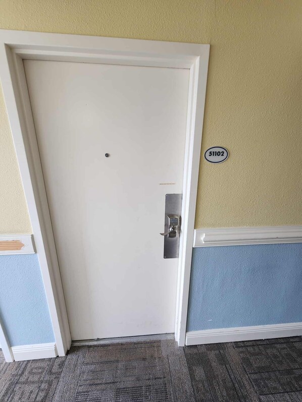 A closed door with a lock, a number plate '51102' on the wall, and a carpeted floor. - Ocean View Condo Sleeps 4! (Myrtle Beach)