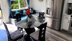 A modern kitchen with a central island, stainless steel appliances, and a view to the outdoors. - The Shalimar Casita, Fits 6 Guests, Smart Tvs, Remodeled Unit, Full Size Kitchen (Riverside)