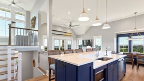 A spacious kitchen with a large island, modern appliances, and a view of the outdoors.