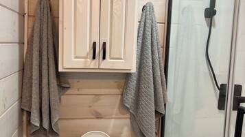 Shower, towels, soap, toilet paper