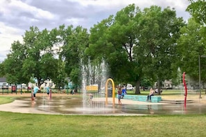 A park with a water fountain, playground equipment, and benches. - Bo’s 3BR Retreat • Hot Tub • Sauna • Den Suite (Billings)