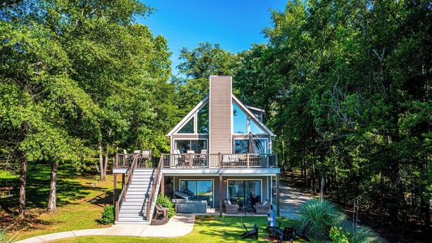 A modern two-story house with a large deck, a staircase, and a well-maintained lawn. - Sparta Escape a perfect getaway (Sparta)