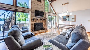 A spacious living room with a fireplace, large windows, and a modern design. - Sparta Escape a perfect getaway (Sparta)