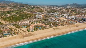 An aerial view of a coastal resort with beachfront properties, a marina, and a golf course. - Paradise Awaits: Beachfront, 2 Master Suites in San José del Cabo (San José del Cabo)