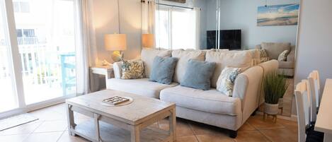 A living room with a sofa, coffee table, and a TV.