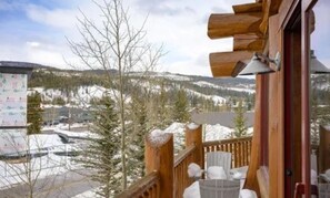 Enjoy breathtaking views of the snow-covered mountains from this cozy balcony.