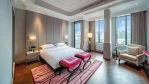 A hotel room with a large bed, two bedside tables with lamps, a chair, and a view of the outdoors. - Seclusion with the mountain (Wuhan)