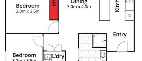 Plano de una casa con balcón, dos dormitorios, comedor, cocina y vestíbulo.
