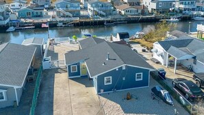 A coastal residential area with houses, a dock, and a marina. - Beautifully updated waterfront home great for families & friends +beach badges. (Little Egg Harbor Township)