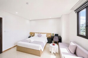 A modern hotel room with a large bed, a desk, a chair, and a view of the city. - Sun Residences Hotel and Apartment (Hanoi)