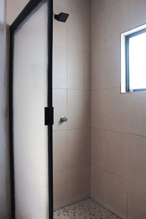 A shower area with a tiled wall, a door with a handle, and a window. - 3-Bedroom Pool Home · Gated Community · 3 Min to Beach · San Carlos Mexico (San Carlos)