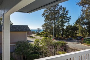 A residential street with houses, trees, and a stop sign. - Spacious House in Walking Distance to the Beach (Aptos)