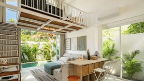 A spacious living area with a balcony, a pool, and a dining area with a view of lush greenery. - Tropical 1BR Private Pool Villa, 8 mins to beach In Uluwatu (Pecatu)
