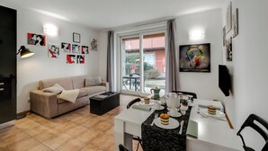 Family Apartment, Multiple Bedrooms (Residence Due Laghi) | Living area | 21-inch flat-screen TV with digital channels - Residence Due Laghi (Ispra)