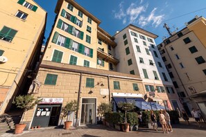 A multi-story building with a ground-level shop and a visible entrance. - Precious House Genova Porto Antico (Genoa)