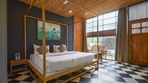A four-poster bed with a checkered floor, a painting on the wall, and a window with curtains. - Nishantam Rishikesh By Aum Wellness (Rishikesh)