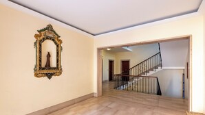 A spacious hallway with a marble floor leading to a staircase with a metal railing. - House Rondinella Genova City Center (Genoa)