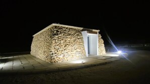 A stone building with a door and a small porch area. - Agricola Chiani (Melendugno)