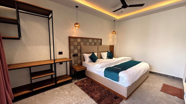 A modern bedroom with a bed, wooden shelves, a ceiling fan, and pendant lights. - Yes Hotel By The Ganges (Rishikesh)